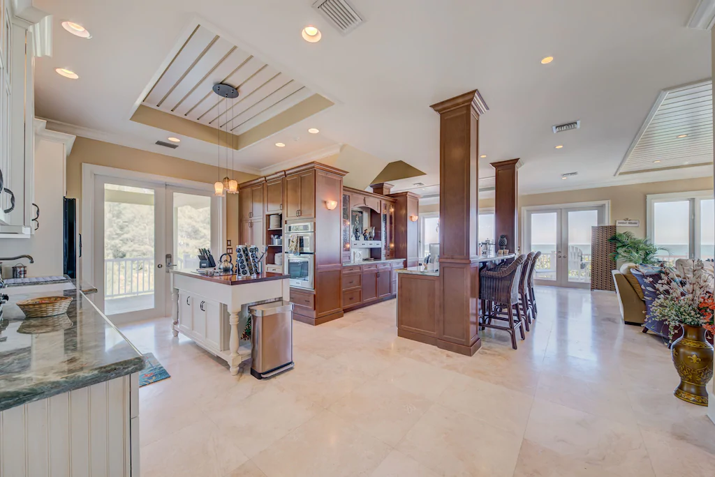 Kitchen/bar area and dining room (living room to the right; grill via doors to the left).