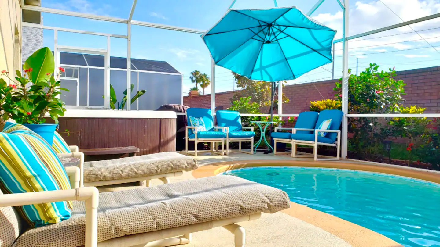 Pool area is bright and sunny, with a separate hot tub spa..