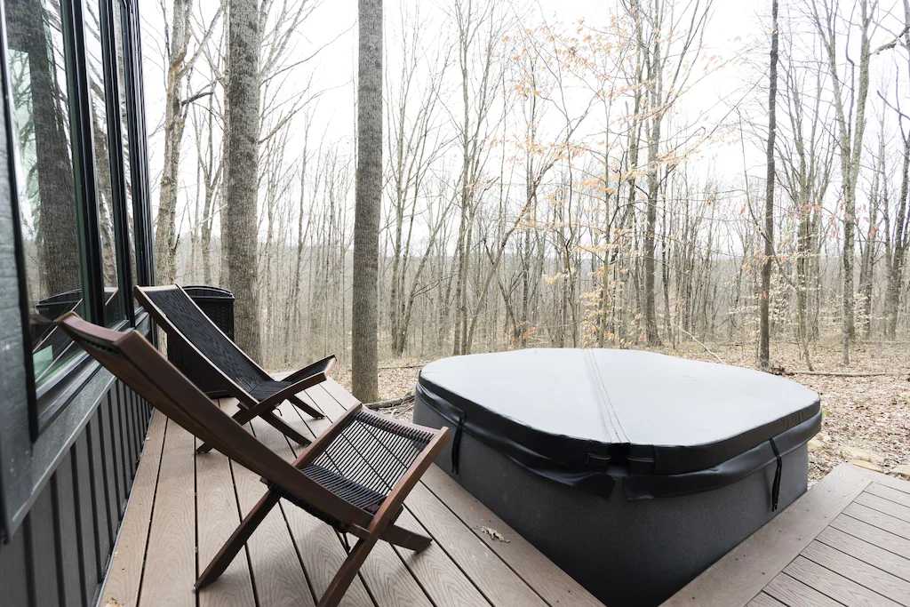 Aspen Haus is surrounded by trees on all sides, and comes equipped with its own hot tub, fire pit, grill, and deck space.