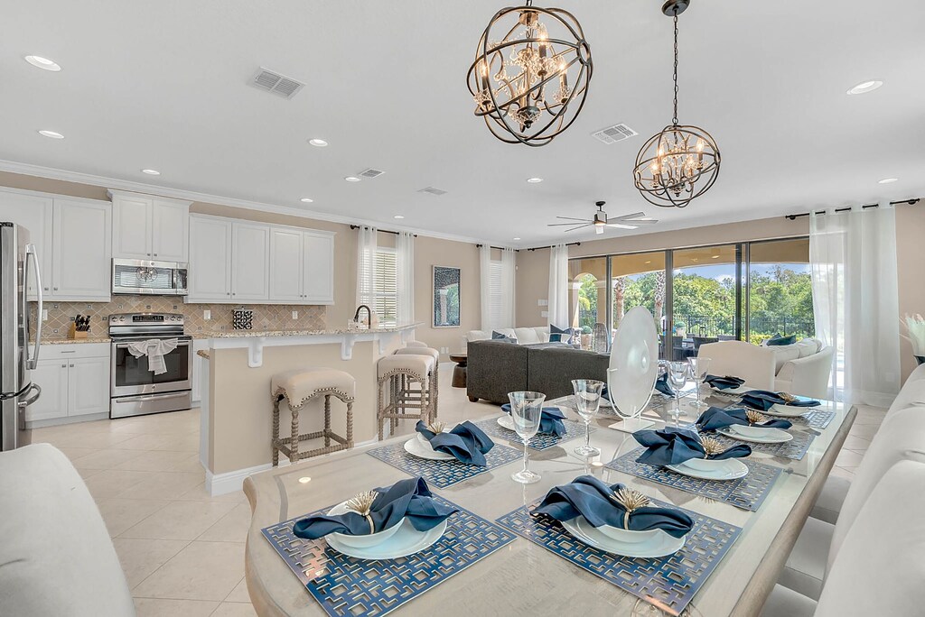 A lovely formal dining table includes six chairs and a bench for four, seating a total of ten people.