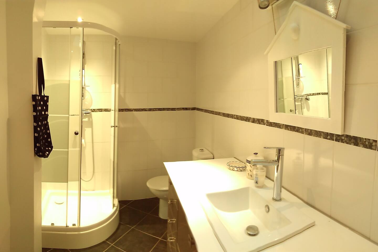 The bathroom has a walk-in shower