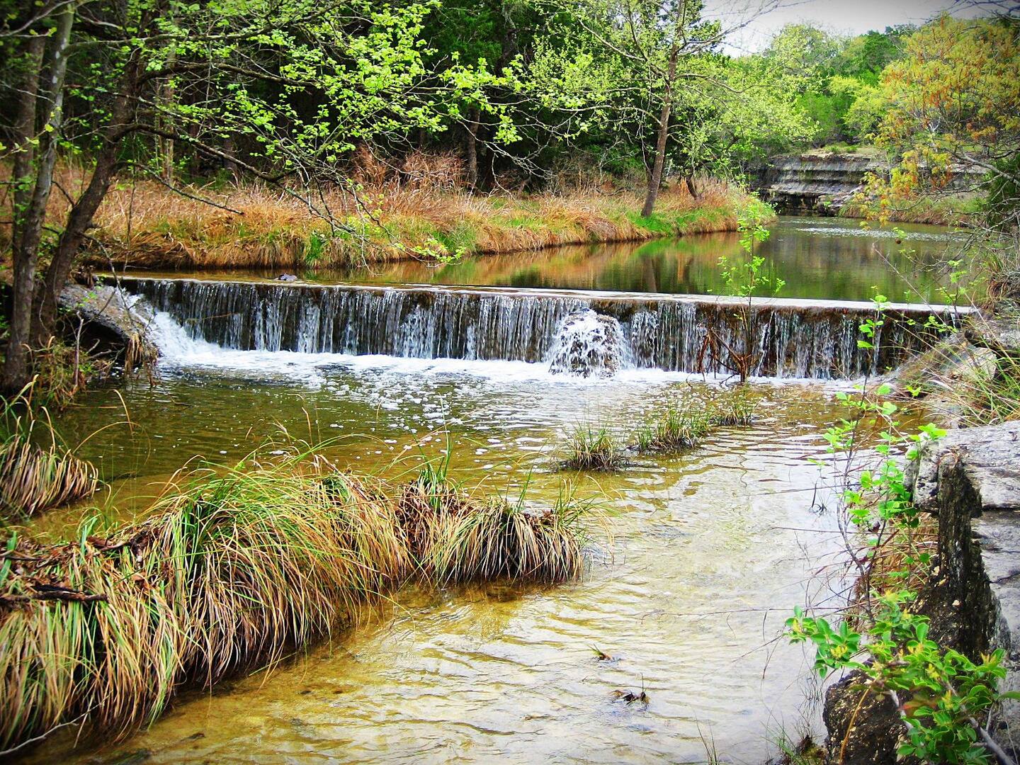 Our property is bordered by the dam, and we have a wonderful stone bench viewing the falls.