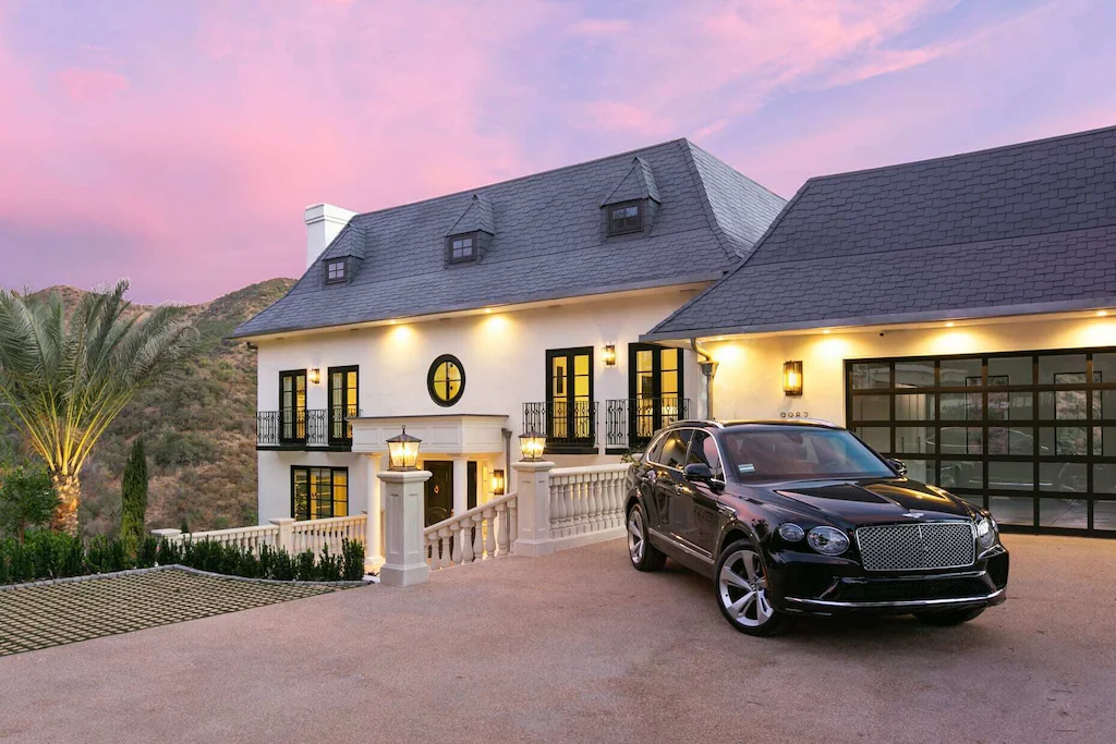 This picturesque French-style Chateau in Beverly Hills, California, has an expansive road leading up to it.