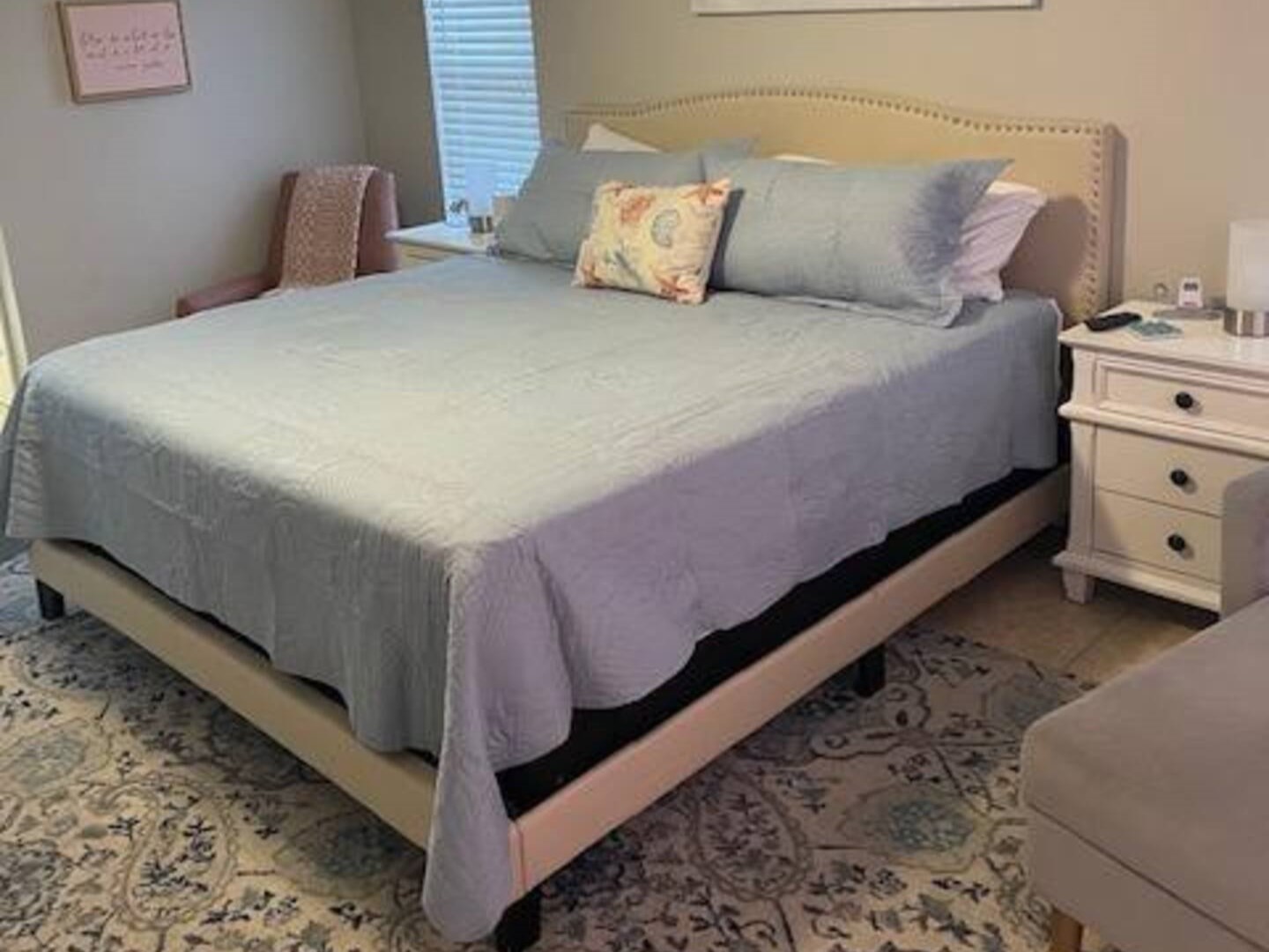 The master bedroom is adorned with a king-sized bed, a 50-inch smart TV, a generous walk-in shower, and offers a view of the pool.