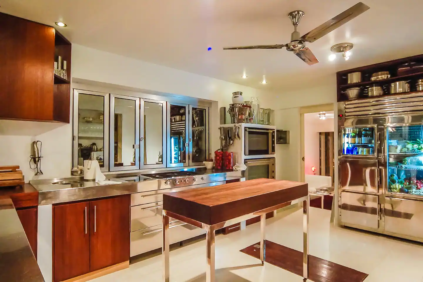 A spacious and well-equipped luxury kitchen with marble countertops, high-end appliances, and ample natural light.