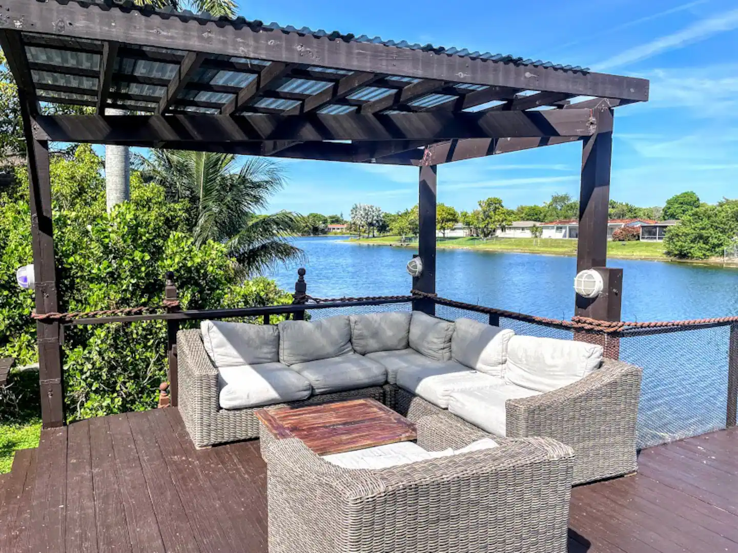 Outside Sofa and Covered Pergula with seating area over looking the Lake.