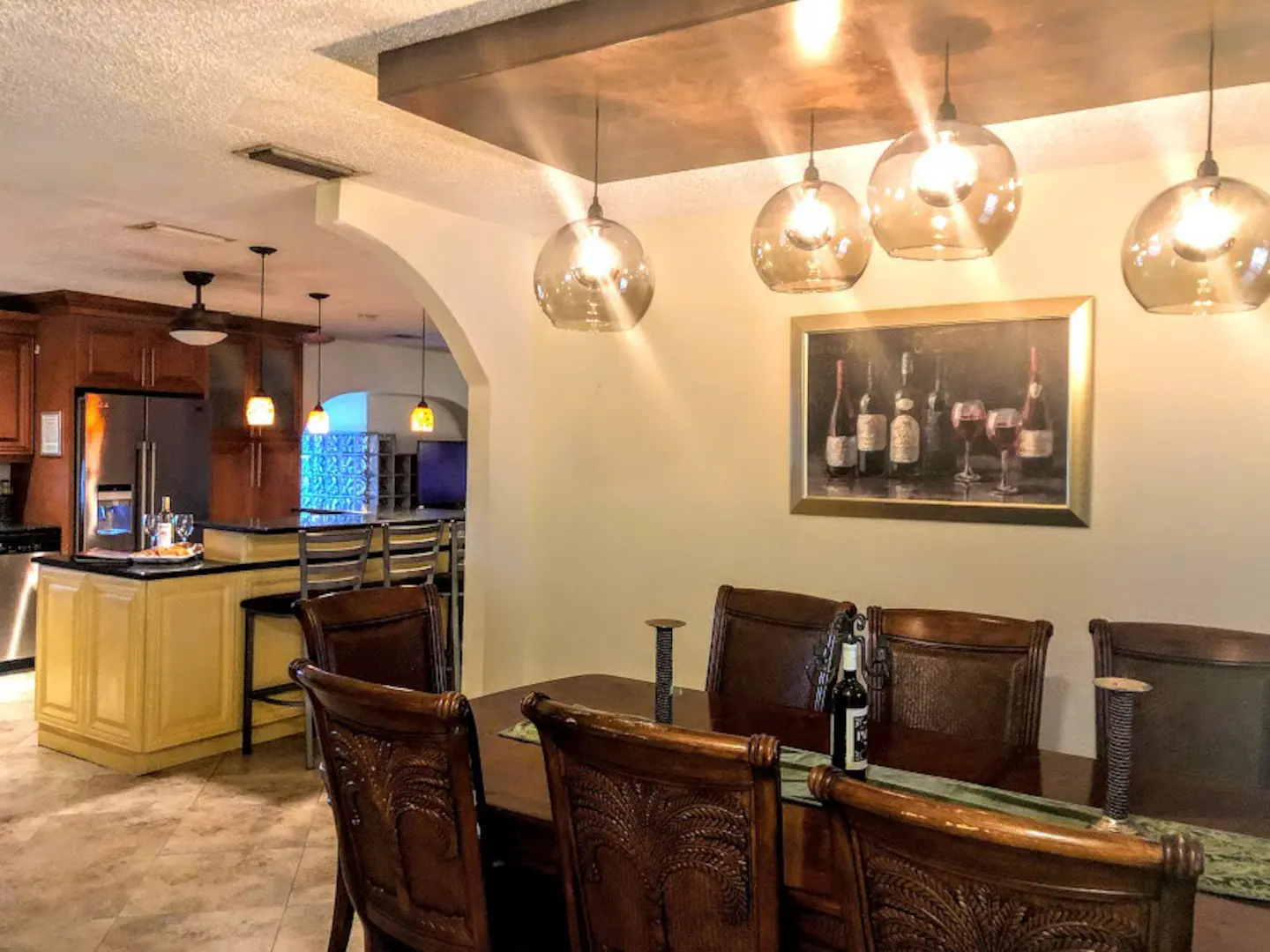 Dining Room next to kitchen with Stainless Steal Appliances and Island with Granite Counter Tops and seating.