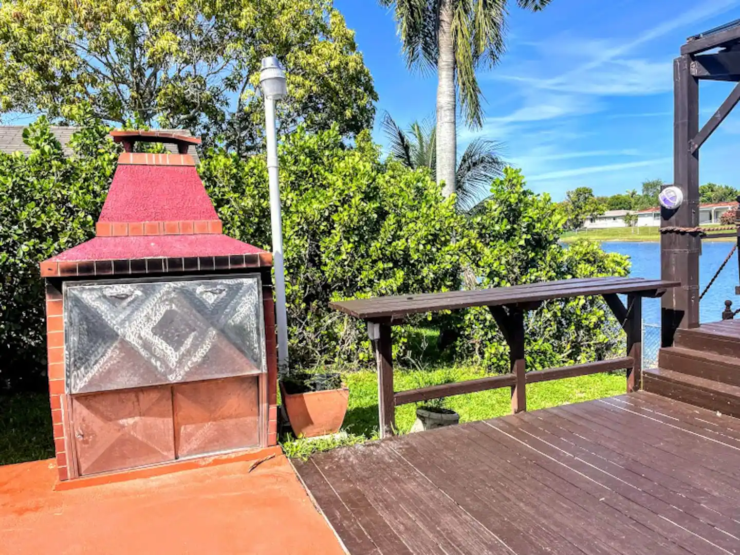 Argentinian BBQ w/ wooden counter top, on deck with lake view.
