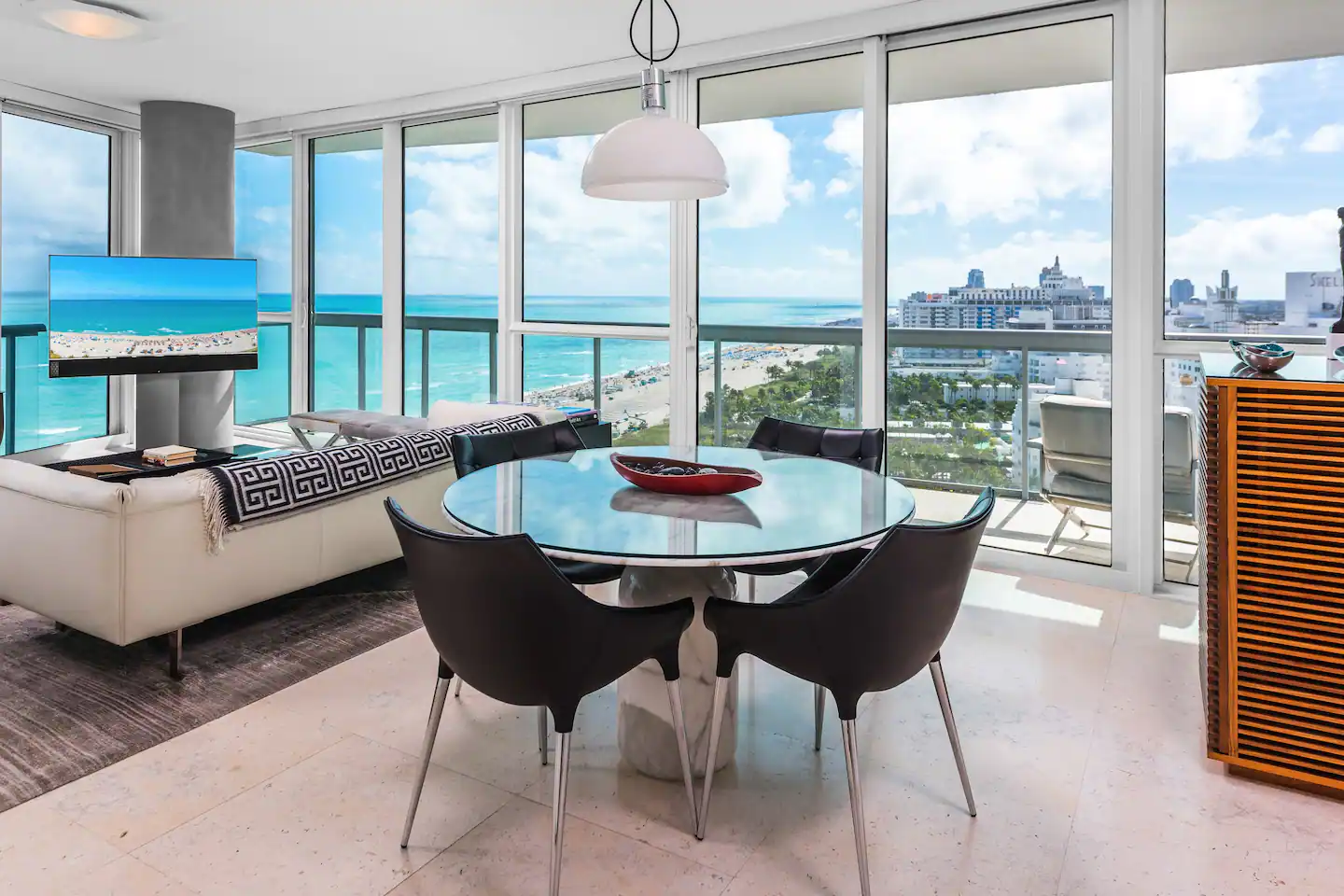 Round marble dining table encourages catching up with friends and family.