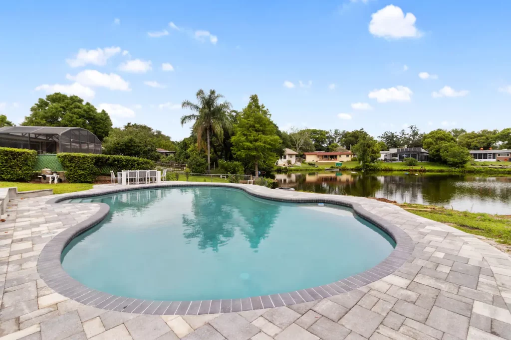 This cheerful bohemian style single-family home with a private heated pool and lake access was recently remodeled.