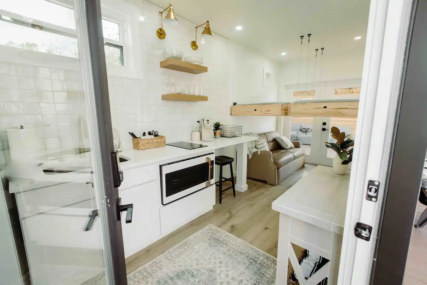 In the kitchenette you’ll find a sizable retro refrigerator, microwave/convection oven, 2-burner stove top, sink and stocked dishes for four people.