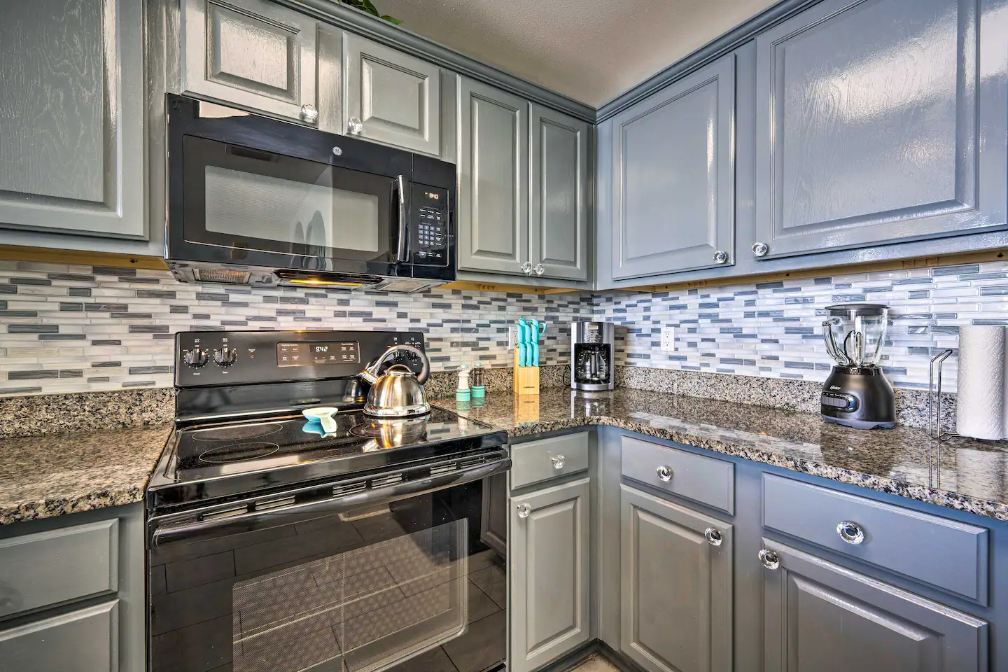 Dishwasher, stove/oven, drip coffee maker, cooking utensils, pots & pans, blender, ice maker, toaster, microwave, spices, dishware & flatware
