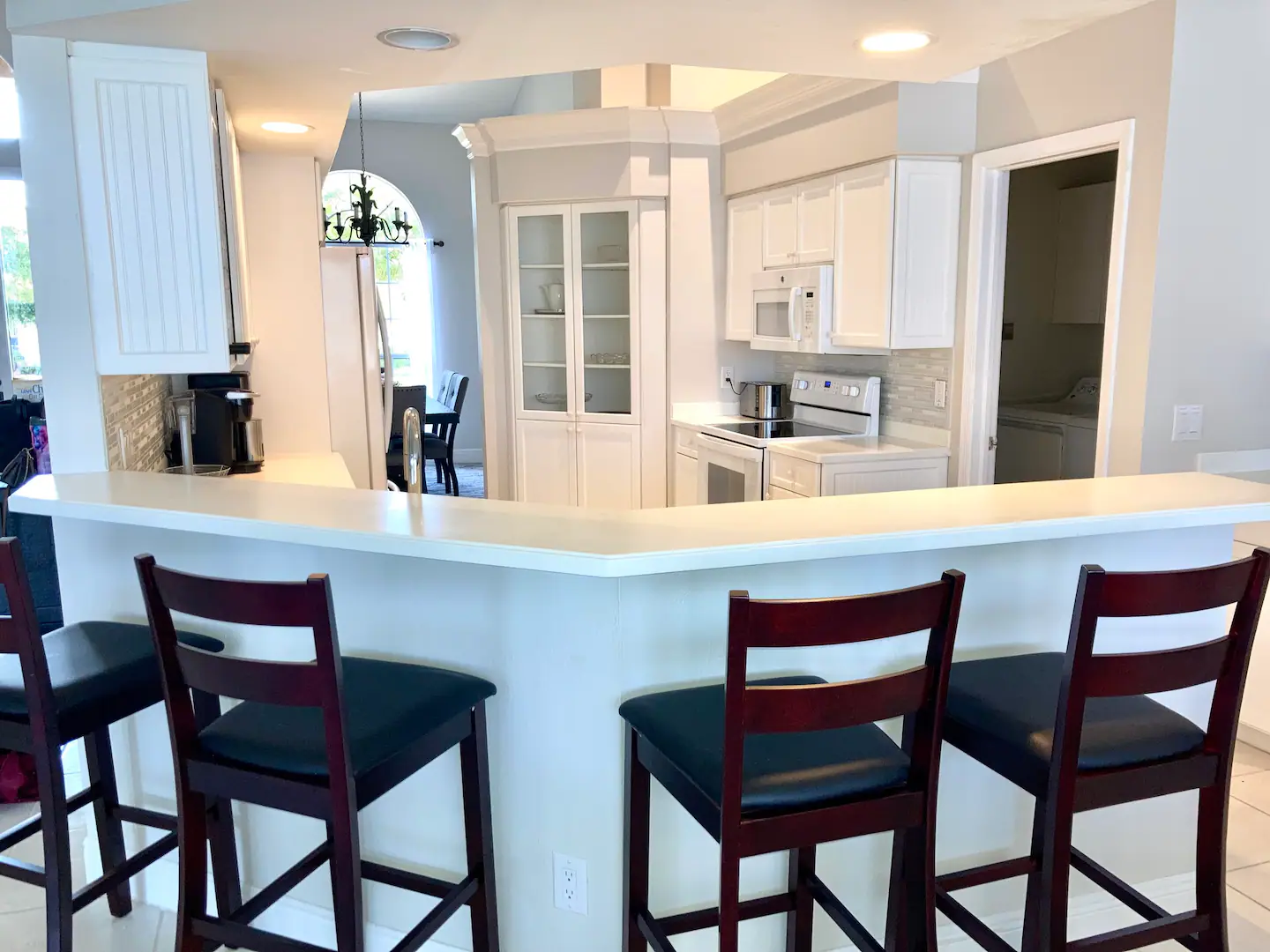Spacious kitchen with kitchen bar and extra seating.