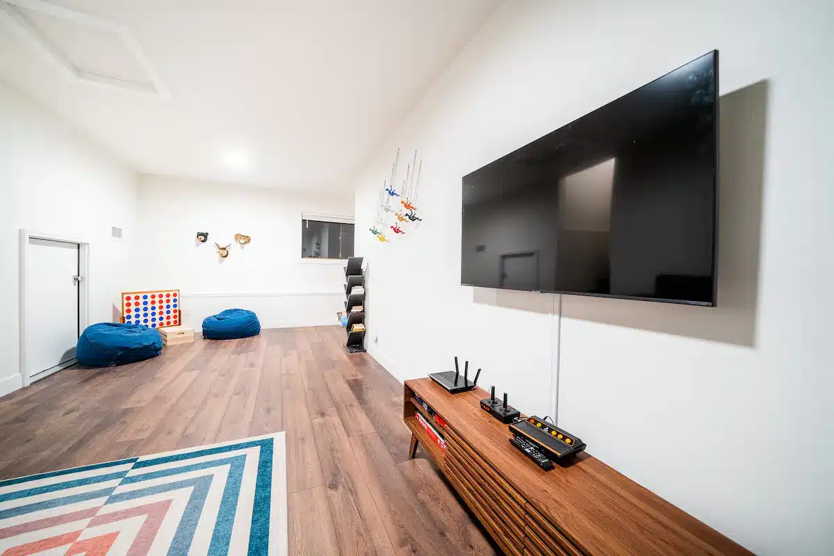 Features a 50" smart TV and two game consoles (retro Atari and retro Nintendo). We also have games for the kids and adults alike.