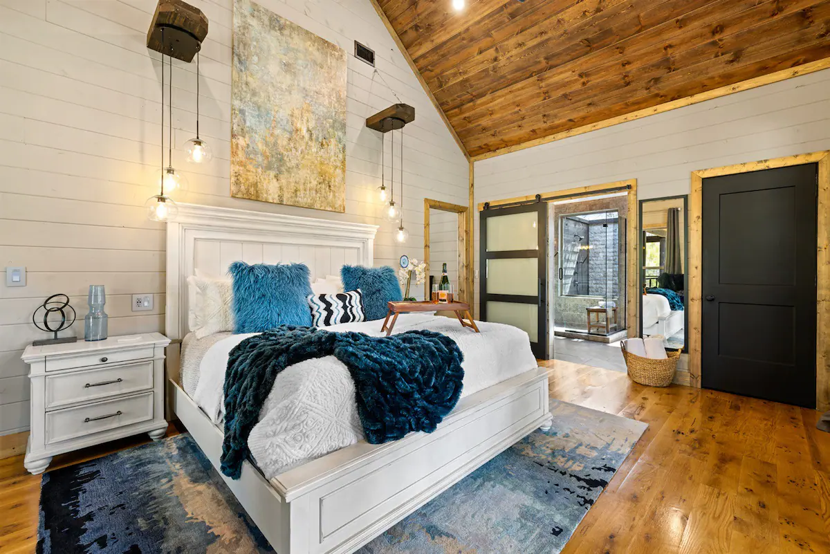 This one bedroom master suite is equipped with a king-sized bed covered in luxurious bedding, wall-mounted fifty-eight-inch smartTV