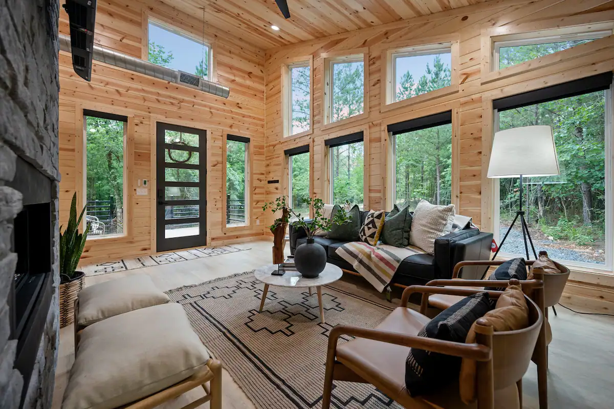 The living room boasts beautiful floor to ceiling windows (with privacy shades when desired).