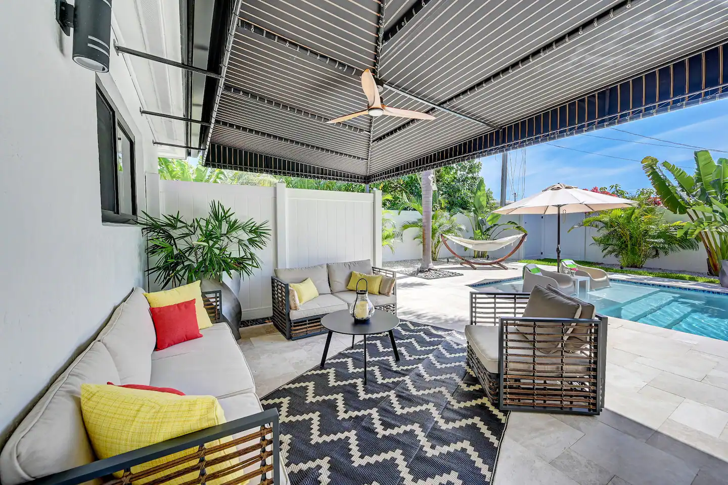 Step into the outdoor haven featuring mosquito repellent, a comfortable sitting area, a hammock, pool chairs, and four lounge chairs.