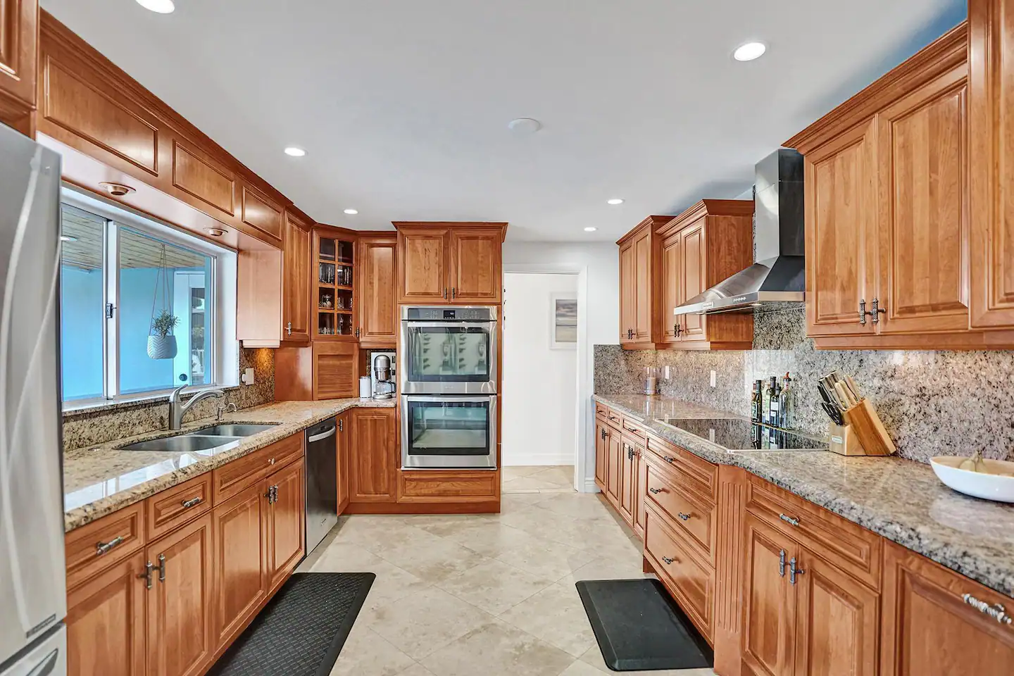 Chef's Kitchen with Induction Cooktop for instant boil, exhaust hood vents to the outside and a large pass through window makes it easy to entertain.